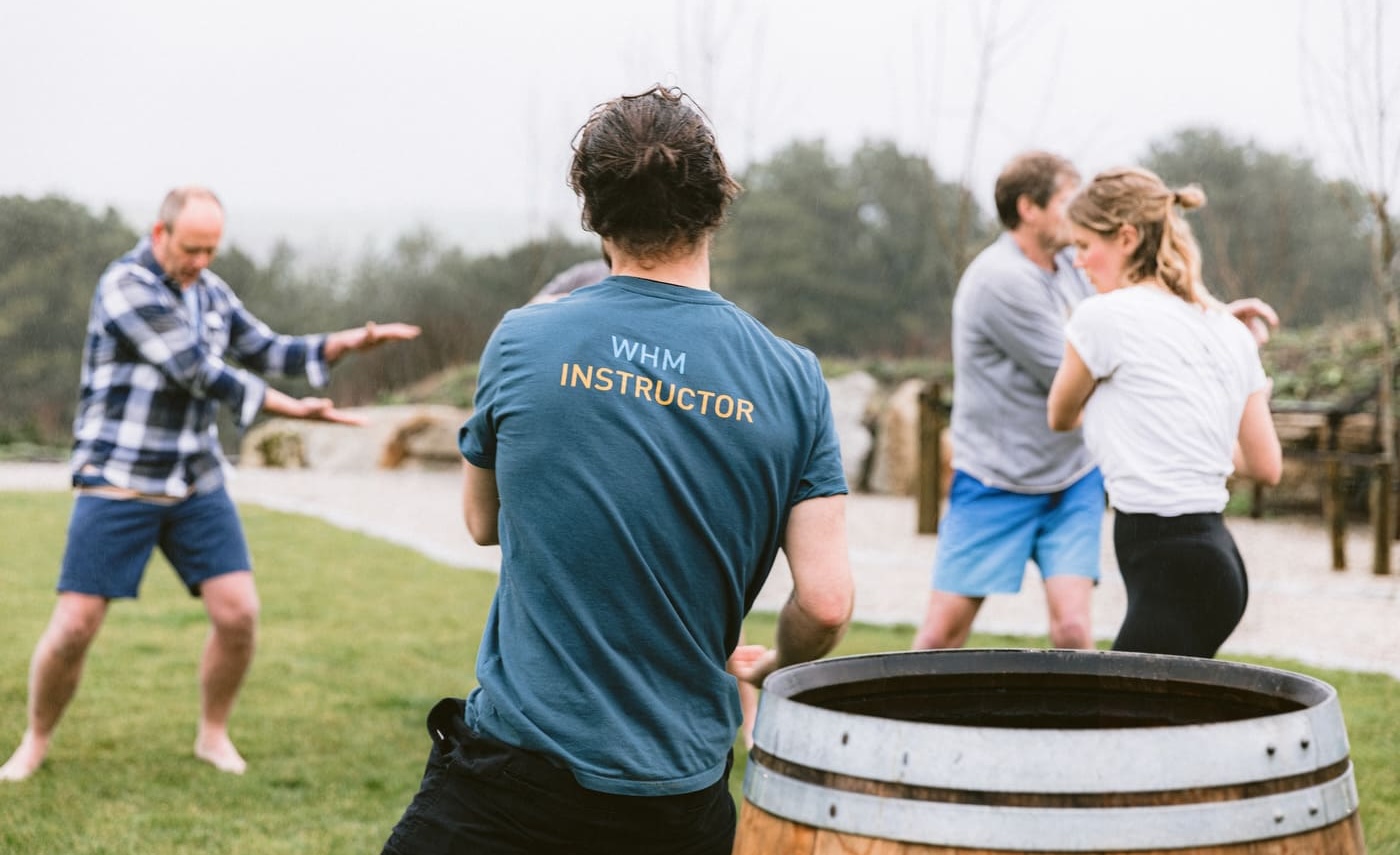 Group taking part in a team-building Wim Hof Method session at Soul Sweats, practising movement exercises outdoors beside the ice bath.
