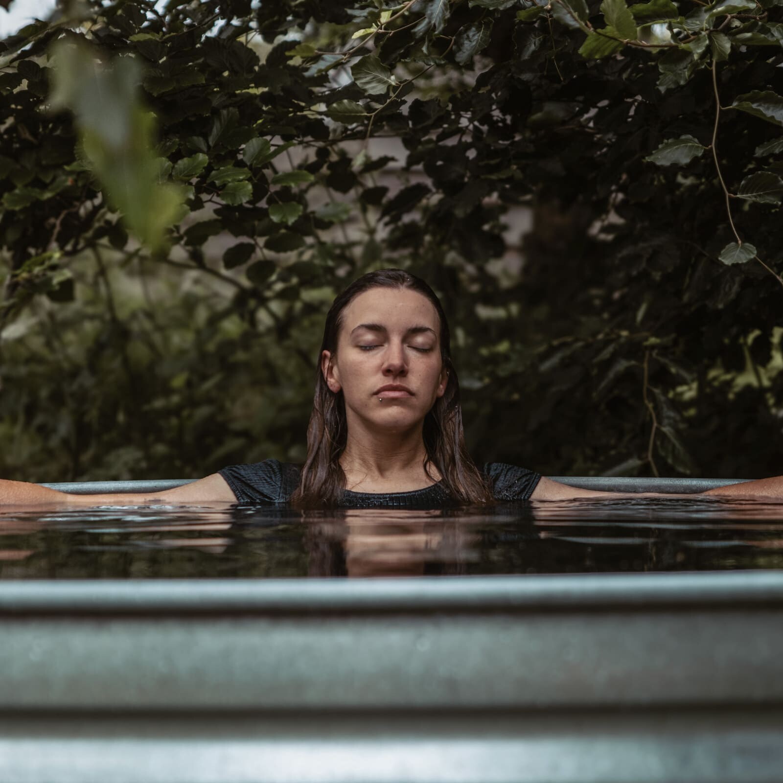 A woman in an ice bath and cold plunge at Soul Sweats